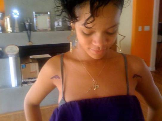 rihanna gun tattoos 2 WTF! Rihanna Covered In Gun Tattoos.